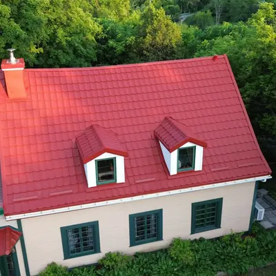 Metal tiles red with white dormers on a heritage home