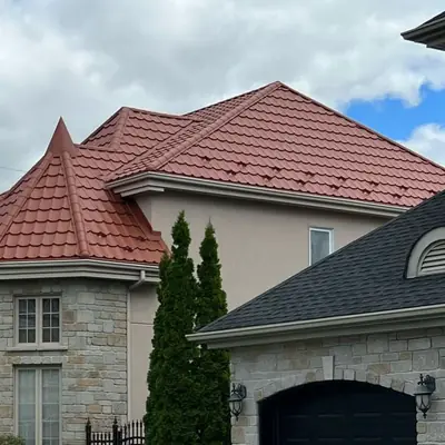 Metal tiles terracotta on a large stone home, Greater Montreal