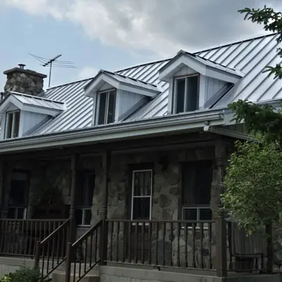 Standing seam roof silver on a fieldstone heritage home